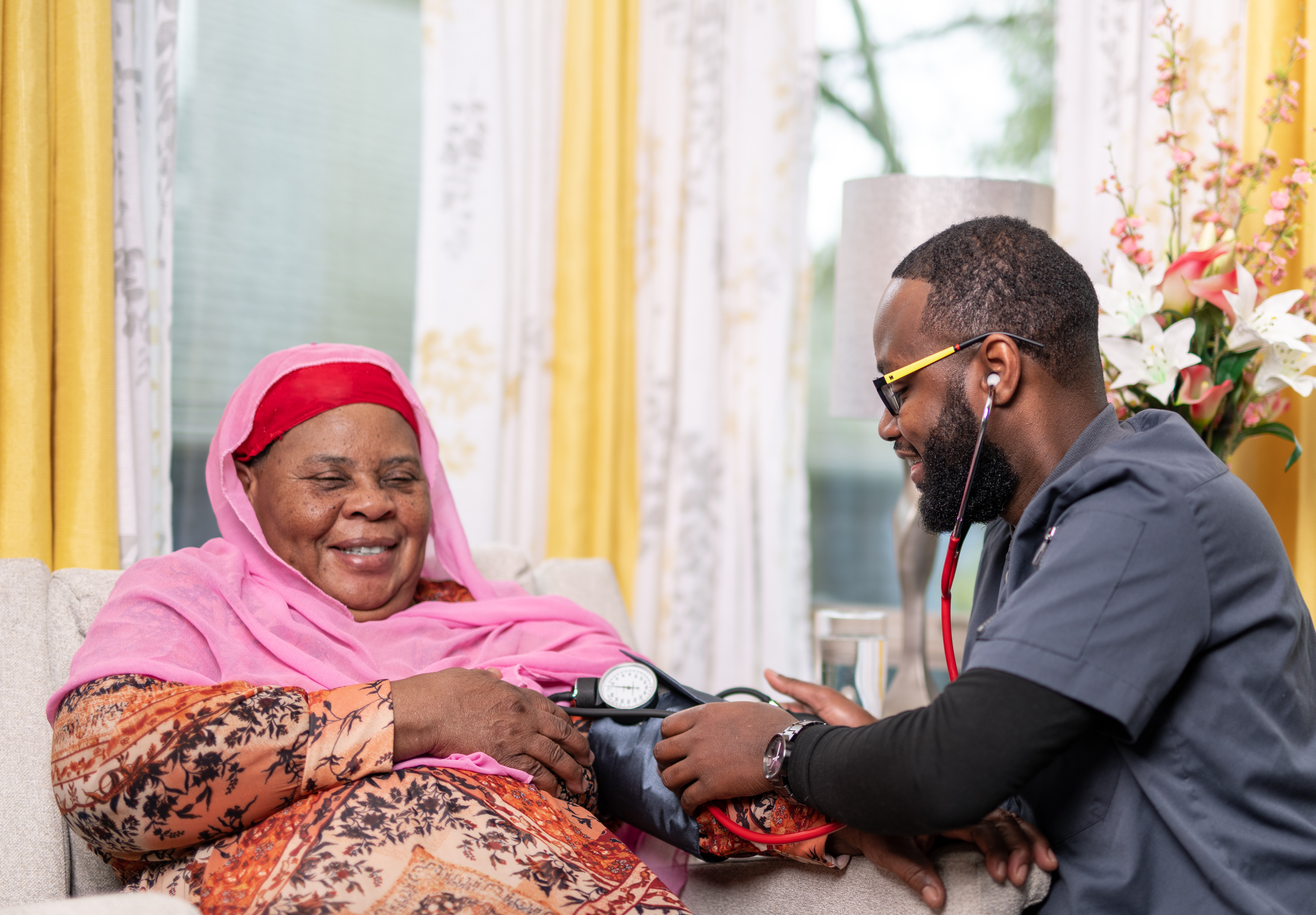 Caregiver checking blood pressure for senior - skilled nursing care